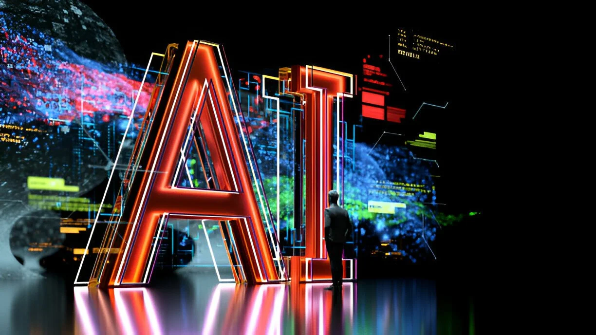 An individual stands in front of a large, illuminated 'AI' sign, surrounded by futuristic digital graphics and data displays, symbolizing the integration of artificial intelligence in modern technology.