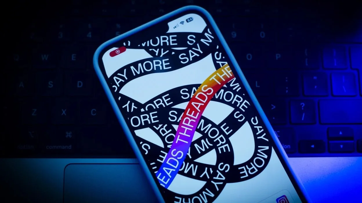 A mobile phone with one iteration of the logo for the new social media app Threads.