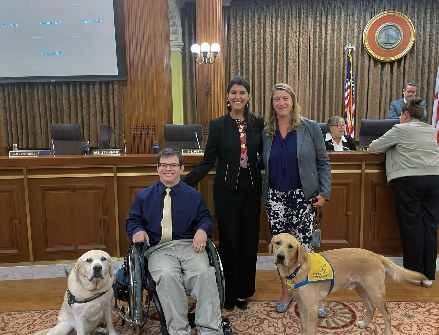Ryan, next to service dog Pico, poses with D.C. Councilwoman Brooke Pinto, Canine Companions puppy raiser, Jaime Werner and her service dog in training, Boston following the recognition of National Service Dog Month by the D.C. City Council