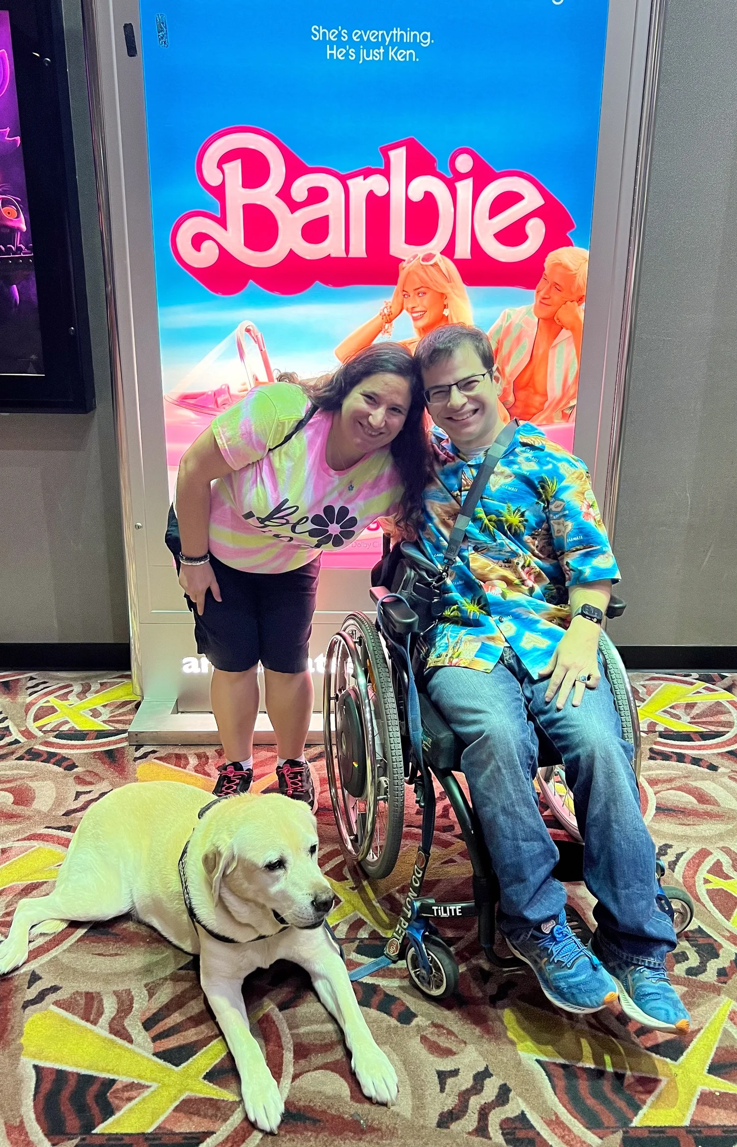 Ryan, Rachael, and Pico pose in front of the poster for Barbie Movie.