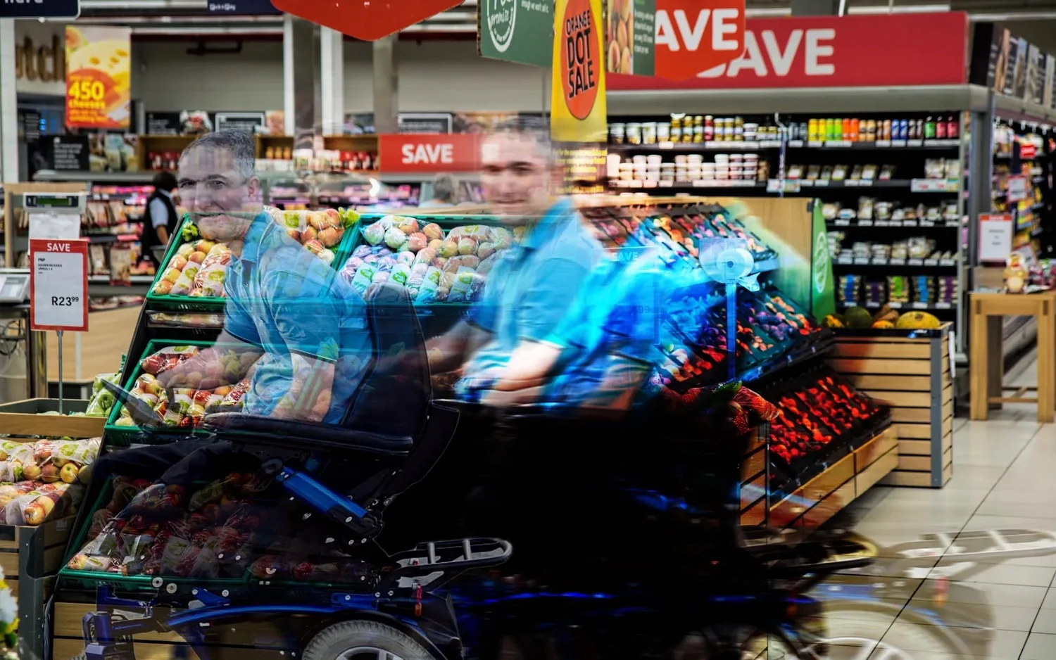 Blurred picture of a wheelchair user in a grocery store.